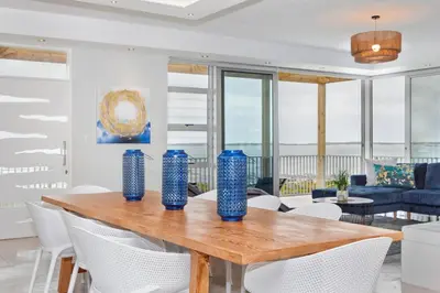 a dining room with blue vases on a wooden table at Blueview on Silversand in Clareport