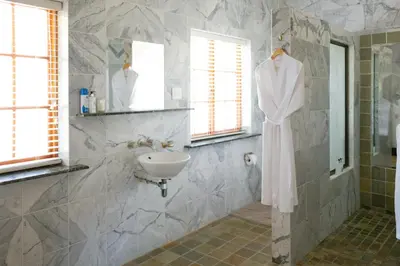 a bathroom with a sink and a shower with a sink at La Roche Estate in Franschhoek