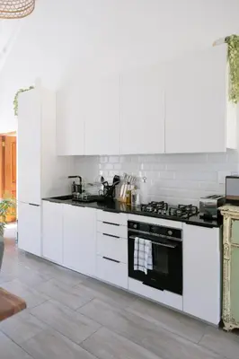 a white kitchen with white cabinets and a stove at La Roche Estate in Franschhoek
