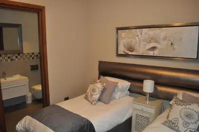 a hotel room with a bed and a mirror at A Perfect Self Catering in Wellington