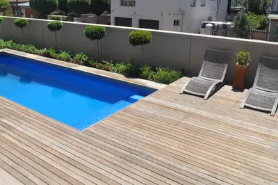 a deck with two chairs and a swimming pool at A Perfect Self Catering in Wellington