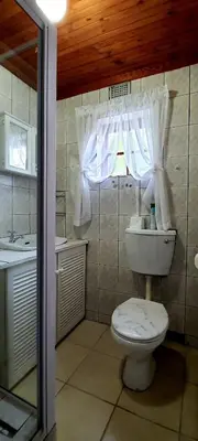 a bathroom with a toilet and a sink at Cozy Cottage +/- 500m from the beach in Cape Town