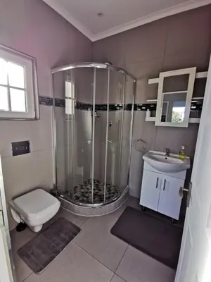 a bathroom with a shower and a toilet and a sink at Zebra Place in Cape Town