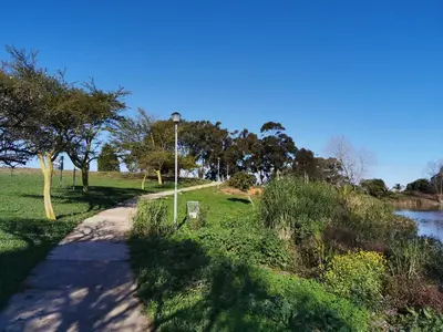 a path in a park next to a river at Zebra Place in Cape Town