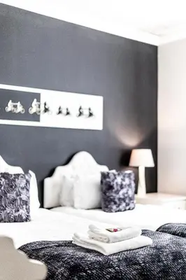 a bedroom with a bed with two towels on it at Seagull Hermanus in Hermanus