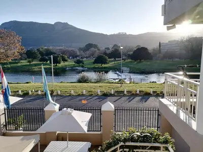 a view from the balcony of a resort with a river at Sunset Boulevard Riverlodge in Paarl