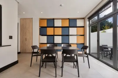 a dining room with a table and chairs at Hotel Krige in Stellenbosch