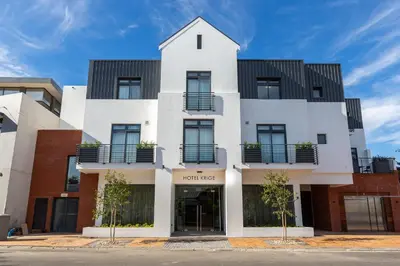 a white building with black roof at Hotel Krige in Stellenbosch