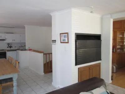 a living room with a kitchen and a dining room at Ocean View in Hermanus