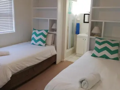 a bedroom with two beds with towels on them at Ocean View in Hermanus