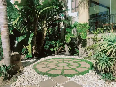 a garden with a stone patio in front of a building at Portifino On Lake G16 The Island Club in Cape Town