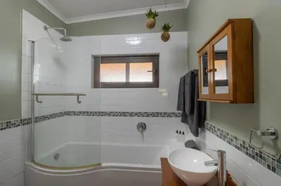 a bathroom with a bath tub and a sink at Steenbok farm cottages -Mongoose cottage in Wolseley