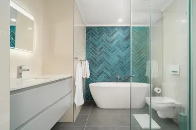 a bathroom with a tub and a sink and a toilet at Dolphin Beach E30 in Cape Town