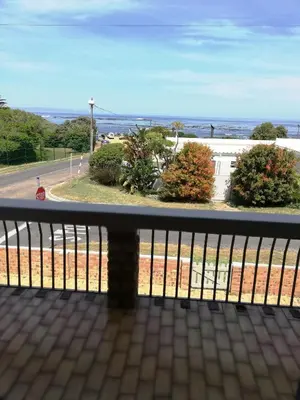 a balcony with a view of the ocean at C the C - Holiday Home in Hermanus