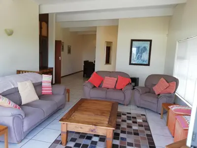 a living room with two couches and a coffee table at C the C - Holiday Home in Hermanus