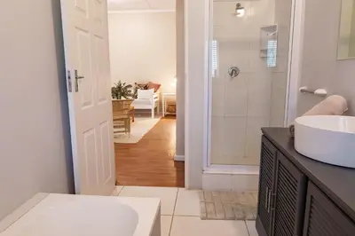 a bathroom with a sink and a toilet and a shower at Hoogwater Garden Cottage in Wolseley