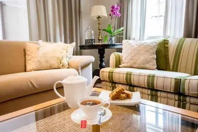 a living room with a cup of coffee and a plate of food at Hoogwater Farmhouse in Wolseley