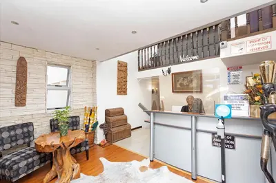 a living room with a counter and a table at Kwantu Guesthouse 1 in Cape Town