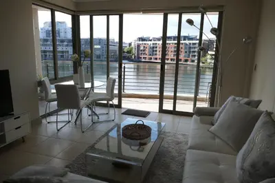 a living room with a couch and a table at Little Venice Self Catering in Bellville