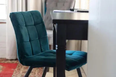 a green chair sitting next to a black desk at 17Peppertree in Cape Town