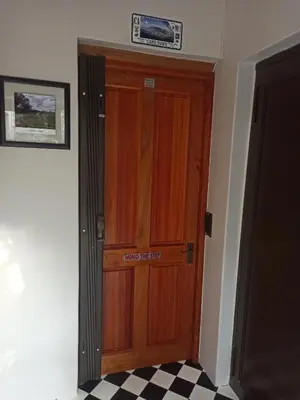 a wooden door with a sign on top of it at 17Peppertree in Cape Town