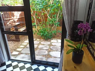 a door leading to a patio with a garden at 17Peppertree in Cape Town