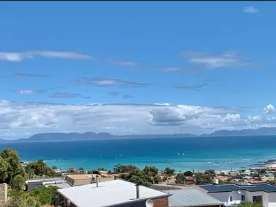 a view of the ocean from a city at On the GBay Villa in Gordonʼs Bay
