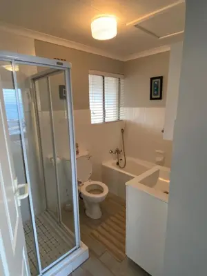 a bathroom with a shower and a toilet and a sink at CView in Hermanus