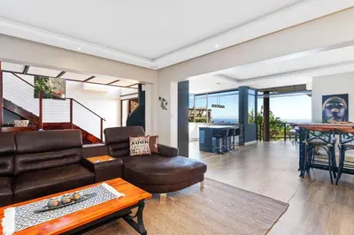 a living room with a couch and a table at Zaria Sun Family in Cape Town