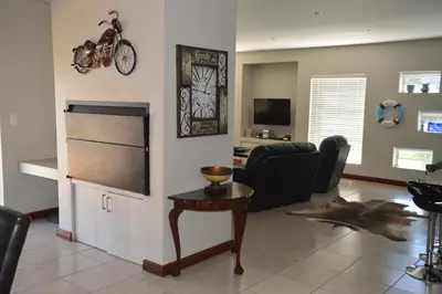 a living room with a couch and a table at Piece of Paradise in Hermanus