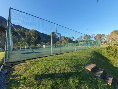 a tennis court with a net on a field at Lagoon Edge in Hermanus