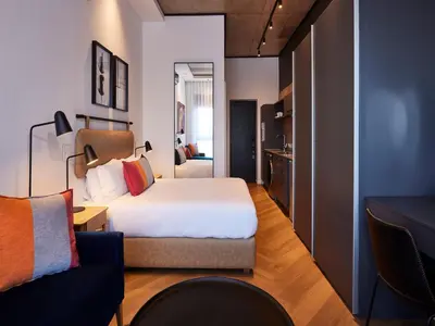 a hotel room with a bed and a couch at Bridgewater Apartments by Century City Hotels in Cape Town