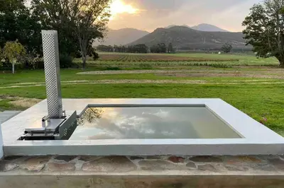 a large pool of water sitting in a field at De Goede Hoop Farmstead in Wilgerhof
