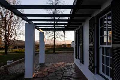 a porch of a house with a pergola at De Goede Hoop Farmstead in Wilgerhof