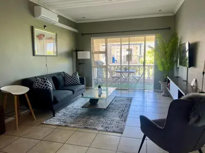 a living room with a couch and a table at The CoziPlace in Cape Town