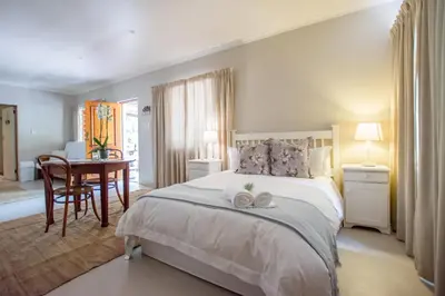 a bedroom with a bed with two towels on it at Hoogwater Cottage in Wolseley