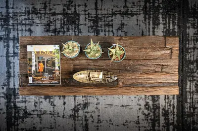 a wooden cutting board with plates and a magazine at Avemore Jan Cats No 3 full back up power in Stellenbosch