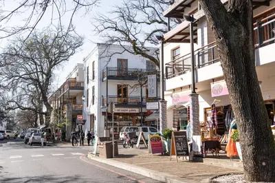 a busy city street with buildings and cars on the road at Avemore Jan Cats No 3 full back up power in Stellenbosch