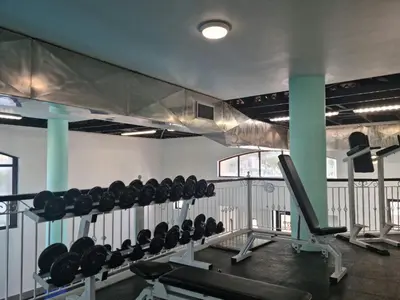 a gym with a bunch of equipment in a room at Island Club by Smart City Stays in Cape Town