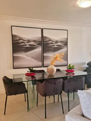a dining room with a glass table and chairs at Island Club by Smart City Stays in Cape Town