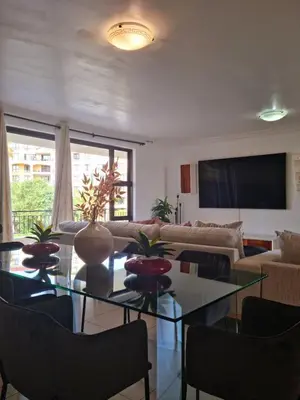 a living room with a glass table and a couch at Island Club by Smart City Stays in Cape Town