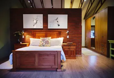 a bedroom with a bed and a brick wall at The Cottage Farm in Stellenbosch