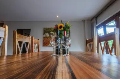 a vase of flowers sitting on top of a table at Home in Cape Town-The Homestead in Stellenbosch
