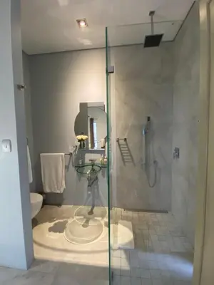 a bathroom with a shower and a sink and a toilet at Beach & Mountain Retreat within a UNESCO Biosphere in Rooiels