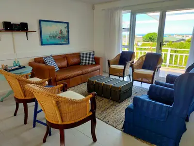 a living room with a couch and chairs at Cottage Amnesia in Bettyʼs Bay