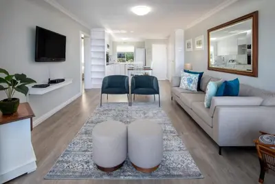 a living room with a couch and a table at 29@Whale Rock Estate in Hermanus