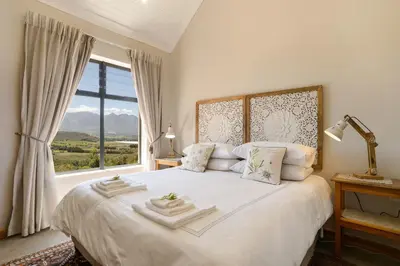 a bedroom with a large bed with a window at Fynbosrust in Wolseley