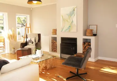 a living room with a couch and a fireplace at House on Charme in Stellenbosch