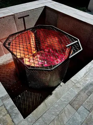 a wire basket sitting on top of a fire pit at 57 on Vermont in Hermanus