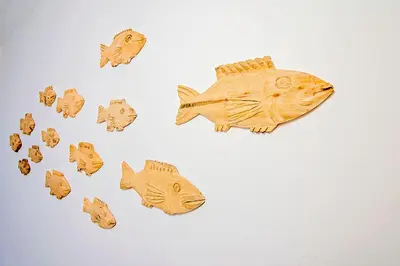 a group of wooden fish cookies on a white table at 57 on Vermont in Hermanus